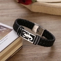 Macro shot of stainless steel magnetic clasp with scorpion totem on braided leather bracelet - Scorpion