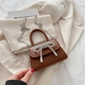 Chic brown mini handbag with silver rhinestone bow and metal chain strap in elegant setting - Brown