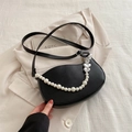 Black crescent leather crossbody bag featuring large pearl chain and silver heart charms - Black