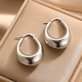 Polished silver chunky teardrop hoop earrings on a luxury champagne satin background - Teardrop Oval Chunky Style (E138)