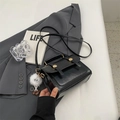 Black vintage leather crossbody bag with golden lock and white plush keychain - With Pendant / Black
