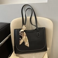 Black tote bag with white contrast stitching and a printed silk scarf on the handle - Black