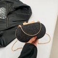 Elegante borsa da sera ovale nera glitterata con chiusura a fiocco dorato e catena - Nero
