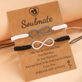 Close-up of infinity symbol bracelets on a Soulmate gift card with woven cord detail - Black & White
