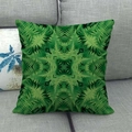 Linen cushion cover with green geometric fern leaf patterns on a grey fabric sofa - Green Fern Geometric Symmetry (13)