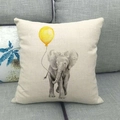 Detailed texture of linen elephant cushion cover placed on a modern grey sofa - Elephant with Yellow Balloon (9)