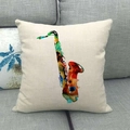Linen pillowcase with abstract watercolor saxophone print on a grey sofa cushion - Saxophone Art Print Style