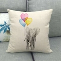 Close-up of linen cushion cover showing elephant and heart balloons on a sofa - Elephant with Three Heart Balloons (8)