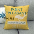 Close-up of yellow linen pillowcase featuring blue vintage typography and whale graphic - Point Pleasant Retro Whale Style (4)