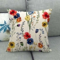 Detalle de vibrante patrón floral en funda de cojín de lino, presentada en un sofá gris - Estilo Floral Acuarela Colorido (7)