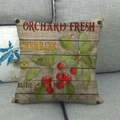 Detail von Leinen-Kissenbezug mit Vintage-Kirschmotiv auf einem grauen Sofa - Kirsche Stil