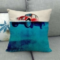Close-up of linen pillow cover featuring a vintage red car print on a grey sofa - Artistic Creative Red Car (4)