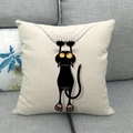 Detail of linen cushion cover featuring a black cartoon cat on a grey fabric sofa - Scratching And Hanging Black Cat (6)