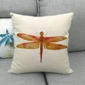 Detailed close-up of a dragonfly print on a linen cushion cover on a grey sofa - Orange-Yellow Dragonfly (4) / 45x45cm