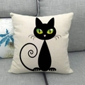 Linen cushion cover featuring a minimalist black cat illustration on a grey sofa - Curled Tail Green Eyed Black Cat (11)