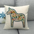 Detail of linen pillowcase with floral Dala Horse print on a soft grey fabric sofa - Square / Dala Horse Vintage Floral Off-white (12)