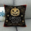 Halloween linen pillow case with gold Jack-o'-lantern and Ghouls text on sofa - Black Gold Skull Pumpkin