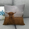 Square linen pillow cover with highland cow print displayed on a modern grey sofa - 18x18 Inch / Realistic Highland Cow in Grass (3)