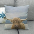 Close-up of a Highland cow printed on a textured linen pillowcase against a sofa background - Highland Cow with Mountain Scenery (5)