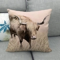 Close-up of linen pillow cover featuring a realistic highland cow print on a grey sofa - Retro Earth Tone Highland Cow (6)