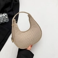 Beige crescent bag with crocodile pattern and golden hardware on elegant black background - Khaki