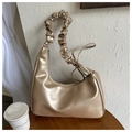 Detail of champagne gold hobo bag with pleated handle and metallic pearl finish - Gold