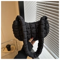Detail shot of black quilted puff shoulder bag with soft texture and chunky handle - Black