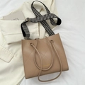 Khaki quilted tote bag with thin handles and houndstraps on a white jacket - Khaki