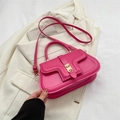 Fuchsia pink vintage saddle bag with golden clasp on an off-white blazer - Rose Pink