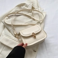 Minimalist beige leather saddle bag with gold ring buckle on textured blazer - White