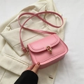 Chic pink saddle bag with golden ring lock and adjustable shoulder strap for women - Pink