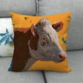 Macro detail of cow oil painting print on rustic linen throw pillow cover on sofa - Ginger Yellow Cow Head Painting