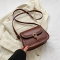 Retro dark brown leather crossbody bag with gold metal ring buckle on beige jacket - Brown