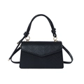 Elegant black snake-textured crossbody bag with knotted handle and gold hardware - Black