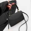 Classic black crossbody bag with snake pattern texture and gold hardware detail - Black