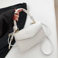 White textured leather crossbody bag with knot handle and gold hardware detail - White