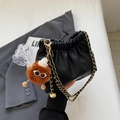 Black ruched bucket bag with gold chain strap and brown monster charm pendant - With Pendant / Black