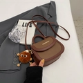 Brown bicolor saddle bag with lychee texture, golden hardware and plush charm - With Pendant / Brown