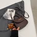 Brown faux leather saddle bag with lychee texture and plush charm accessory - With Pendant / Coffee