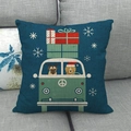 Detail of linen cushion cover showing a cartoon bus with dogs and holiday scene on sofa - Christmas Theme Cyan Bus With Gift Boxes Style (5) / 18x18 Inch