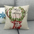 Detail of Christmas reindeer linen pillow cover with Happy Holidays text on grey sofa - 18x18 Inch / Beige Linen Red Reindeer Wreath Happy Holidays
