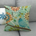 Detail of linen pillowcase with vibrant bird and floral Bohemian print on gray sofa - Tiffany Blue Bird Style (17)