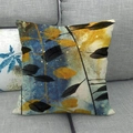 Close-up of linen pillowcase with autumn leaves pattern on a grey fabric sofa - Navy Yellow Black Artistic Branches (5)