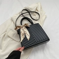 Quilted black handbag with V-shaped stitching and decorative silk scarf detail - Black