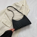 Minimalist black quilted underarm bag with wave stitching and gold hardware - Black