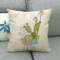 Detail view of linen texture on green cactus pattern throw pillow case on sofa - Colorful Potted Cactus Illustration (13)