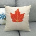 Detail of linen cushion cover with vivid orange maple leaf print on a beige textured fabric - Realistic Orange Maple Leaf Style (5)
