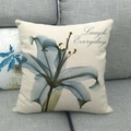 Detail of linen cushion cover featuring lily floral print and Laugh Everyday text on sofa - Blue-Green Lily Laugh Everyday (9) / 18x18 Inch