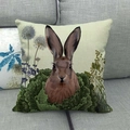 Linen Easter pillow cover with brown rabbit and green foliage on a grey sofa - Brown Hare Peeking Style / 45x45cm