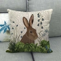 Close-up of linen pillowcase with vintage rabbit print on a gray sofa fabric - Oatmeal Vintage Newspaper Rabbit / 45x45cm